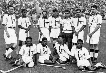The Indian hockey team, captained by Dhyan Chand (standing second from left), after winning the finals at the 1936 Summer Olympics – their third of six consecutive Olympic golds